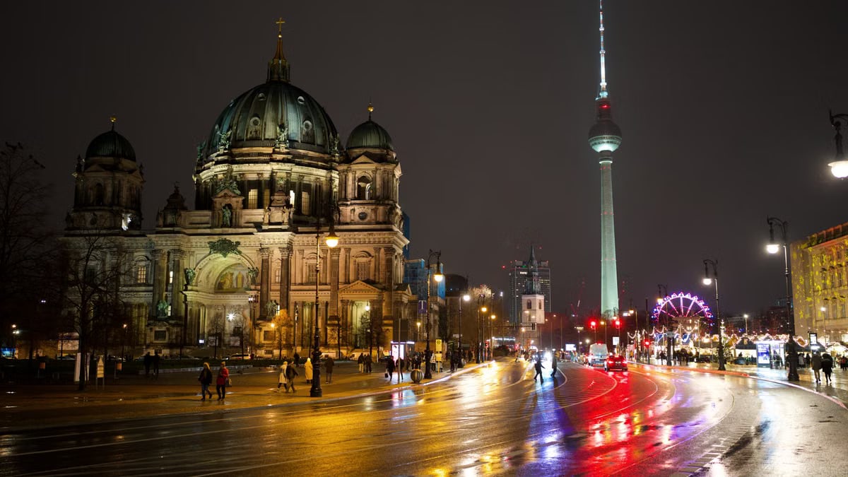 A captivating night scene featuring Berlin Cathedral and Fernsehturm illuminated in Berlin, Germany.